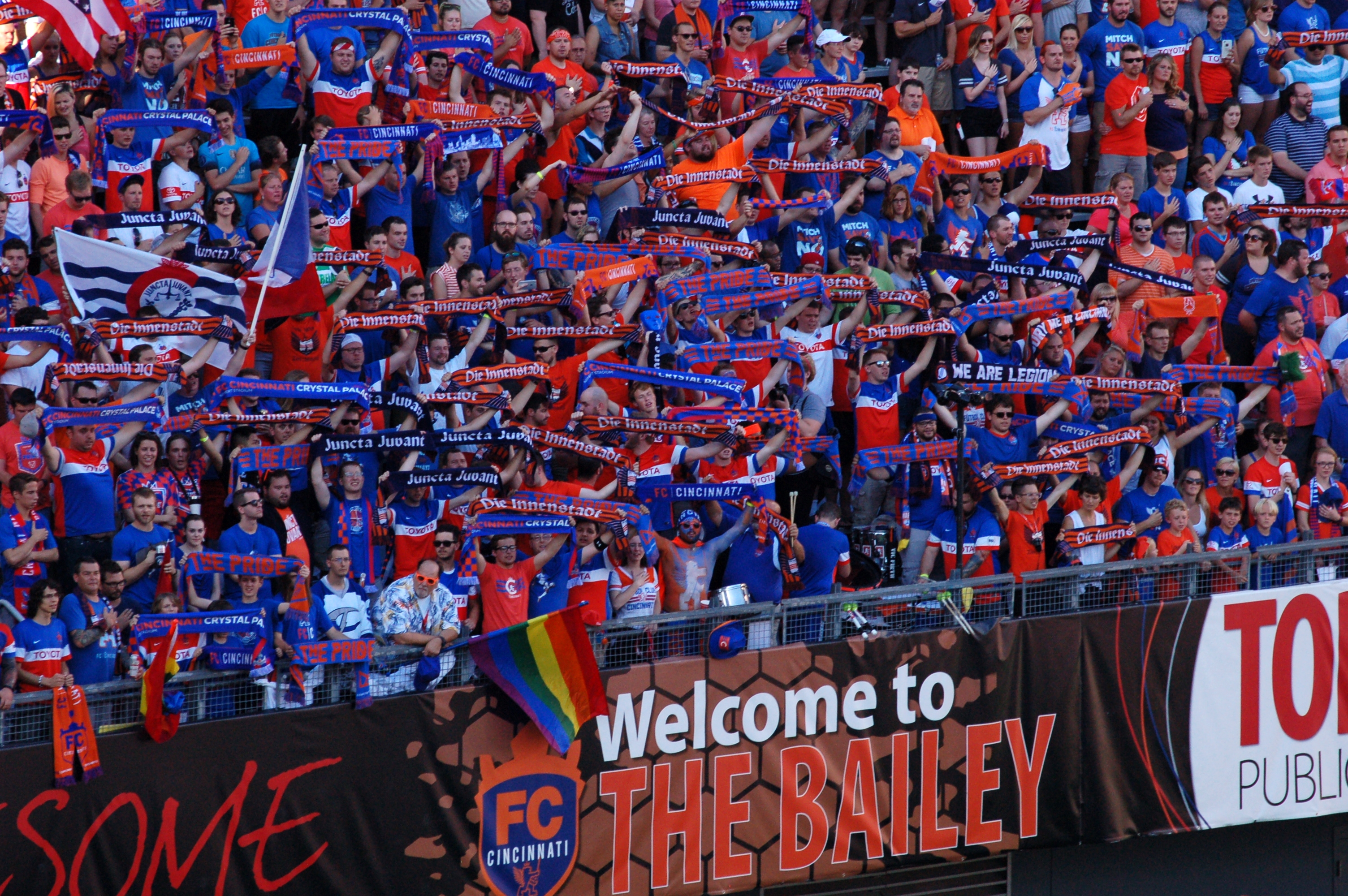 Club football supporters holding scarves in the stands